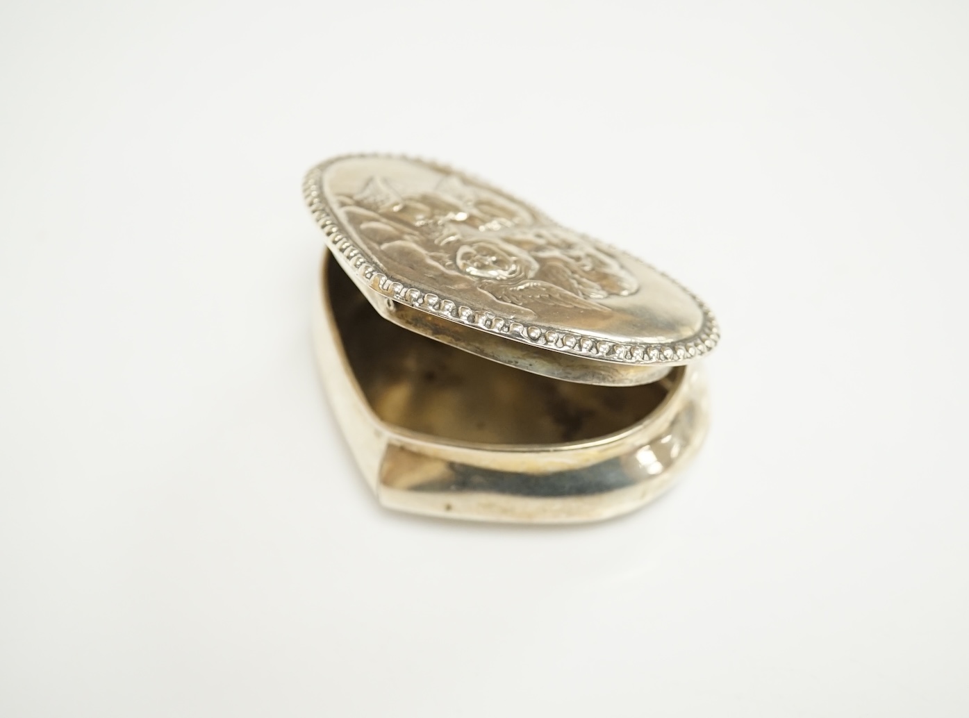 A group of assorted silver including a George III Irish silver basing spoon, Dublin, 1804, 29.5cm, a similar sauce ladle, two Georgian berry spoons, a late Victorian heart shaped photograph frame, a heart shaped pill box